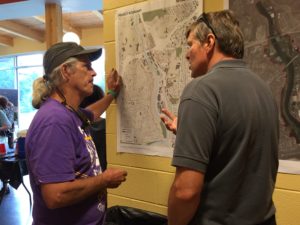 Photo above: River Arts District property owner Bill MacCurdy looks over a map with City Public Works employee Marcus Barksdale during the RAD form-based code kickoff meeting June 17.
